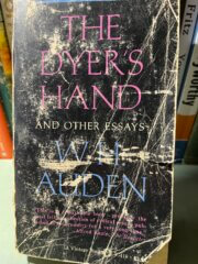 This is a picture of a battered and creased black paperback book cover. The black cover with purple and blue fonts is abraded and scuffed but lovingly so